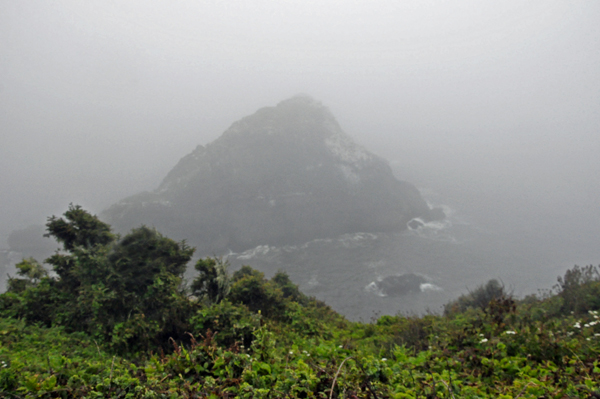 The fog is so heavy that the rocks down below can barely be seen.